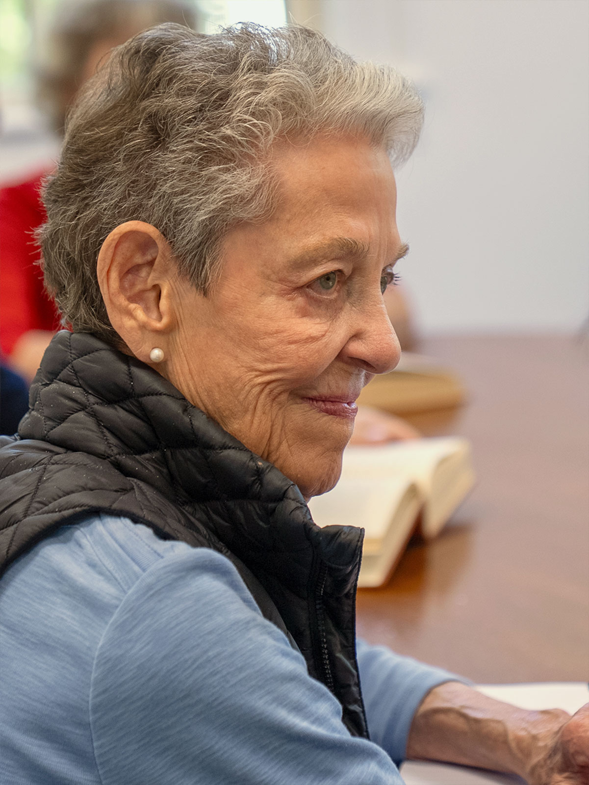 A Harvard Institute for Learning in Retirement member listens in class.