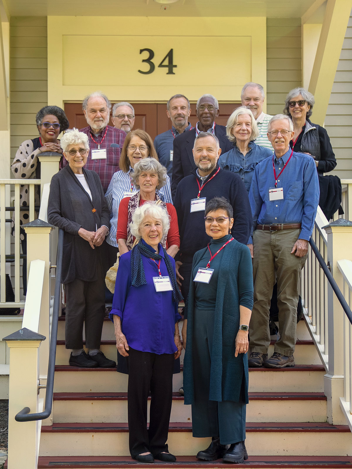 A group of Harvard Institute for Learning in Retirement members pose for a photo on the building's steps.